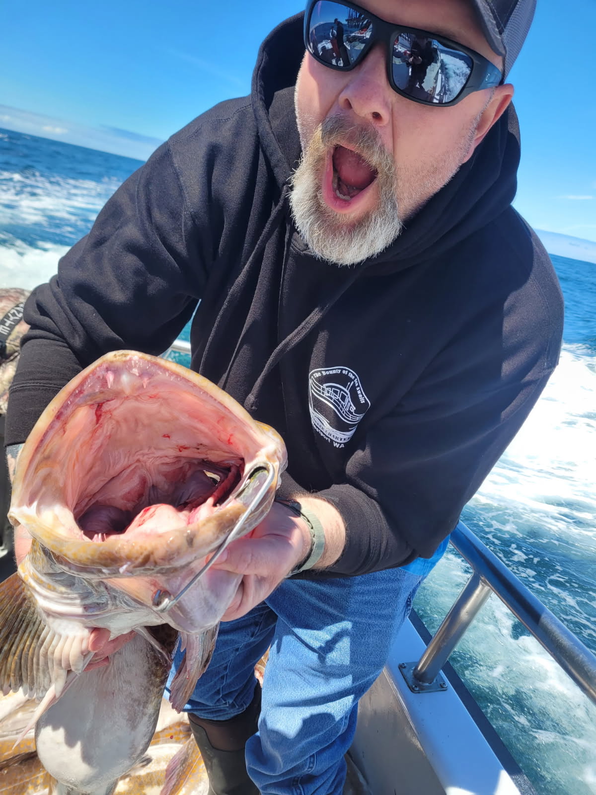 Melvin T. Bennett going mouth-to-mouth with a giant lingcod