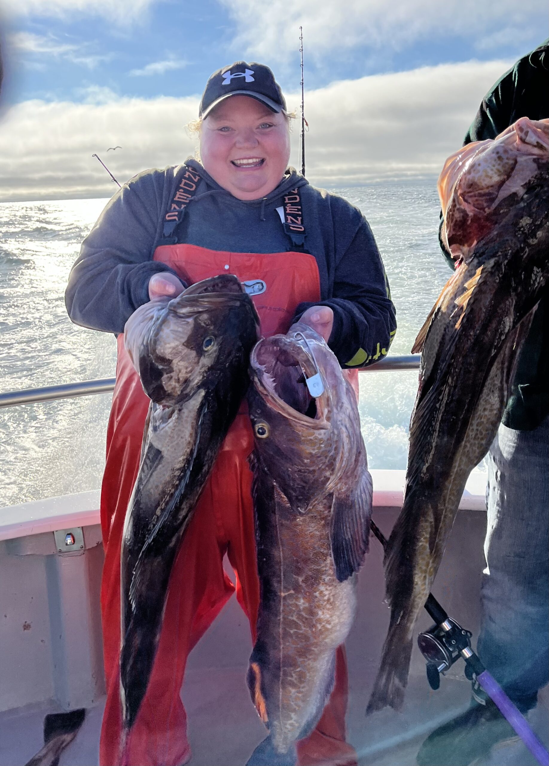 Morgan Northern smiling with an armful of lingcod