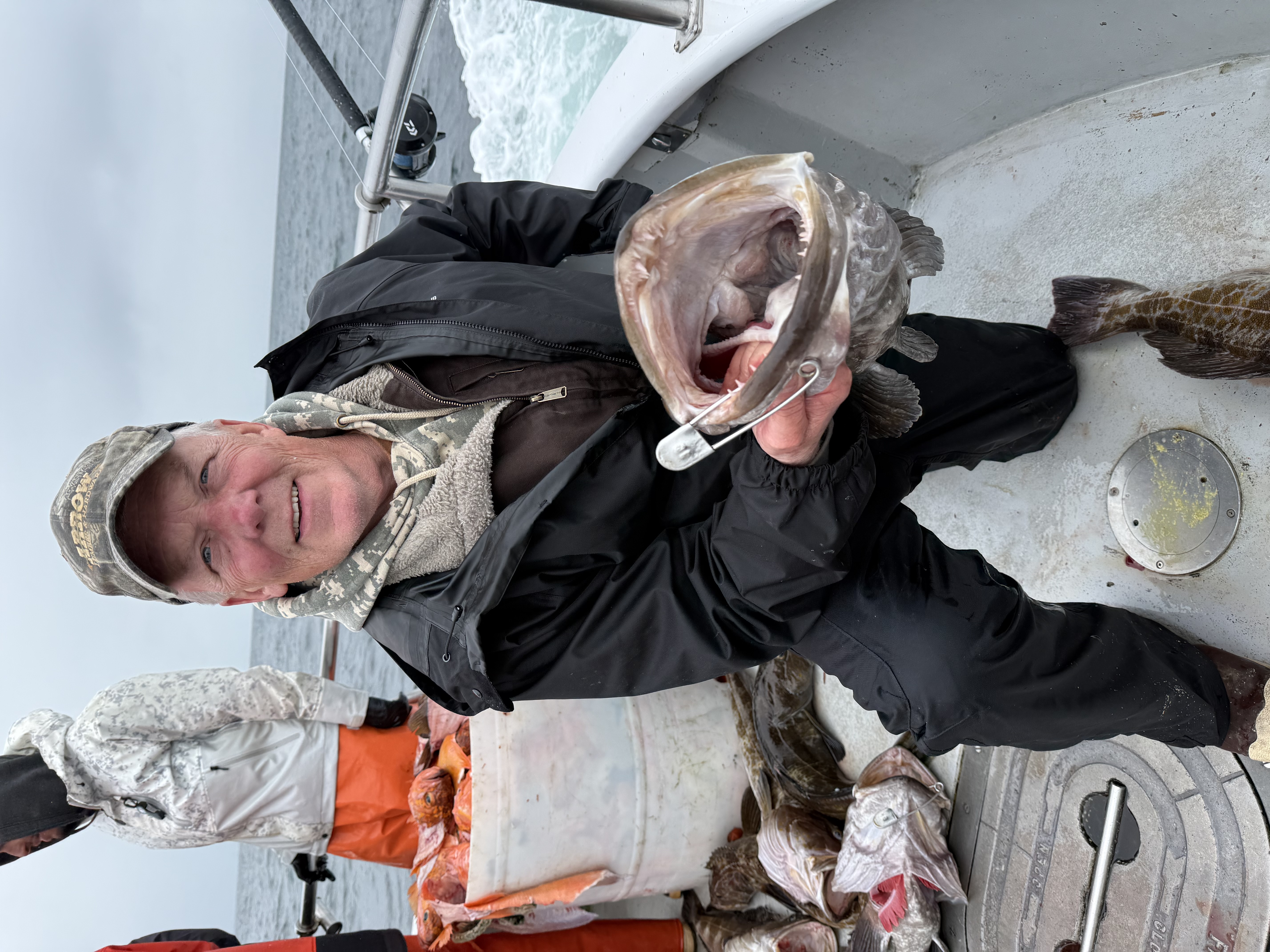 Dale McKenna kneeling with a big lingcod